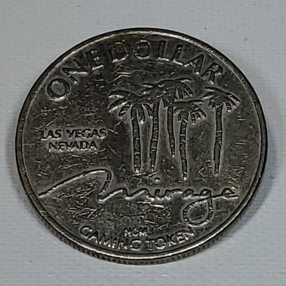 VINTAGE MIRAGE CASINO SILVER ONE DOLLAR GAMING TOKEN 1989 BY NEVADA COIN MINTING - Picture 1 of 4